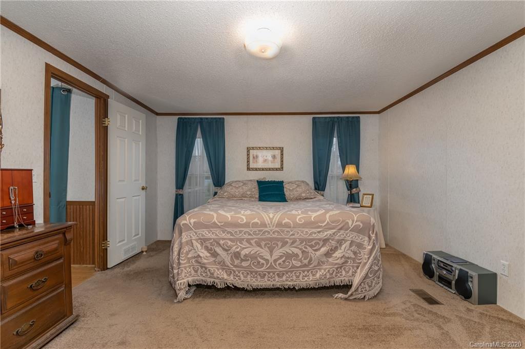 526 Parris Road Rutherfordton, NC 28139 - Photo 17 of 27 a bed sitting in a spacious bedroom next to a window