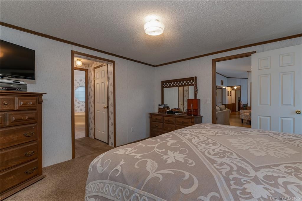 526 Parris Road Rutherfordton, NC 28139 - Photo 18 of 27 a bedroom with a bed and a flat screen tv