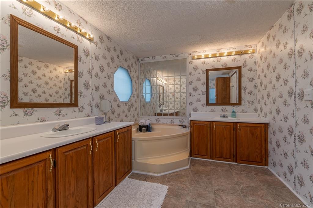 526 Parris Road Rutherfordton, NC 28139 - Photo 19 of 27 a bathroom with a double vanity sink mirror and bathtub