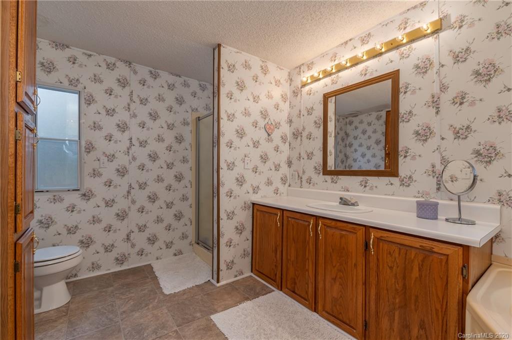 526 Parris Road Rutherfordton, NC 28139 - Photo 20 of 27 a bathroom with a toilet sink and mirror