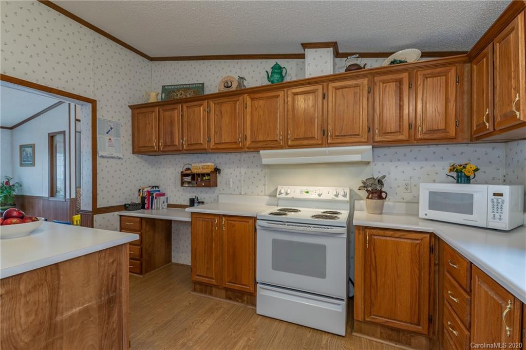 526 Parris Road Rutherfordton, NC 28139 - Photo 23 of 27 a kitchen with stainless steel appliances granite countertop a sink stove and refrigerator