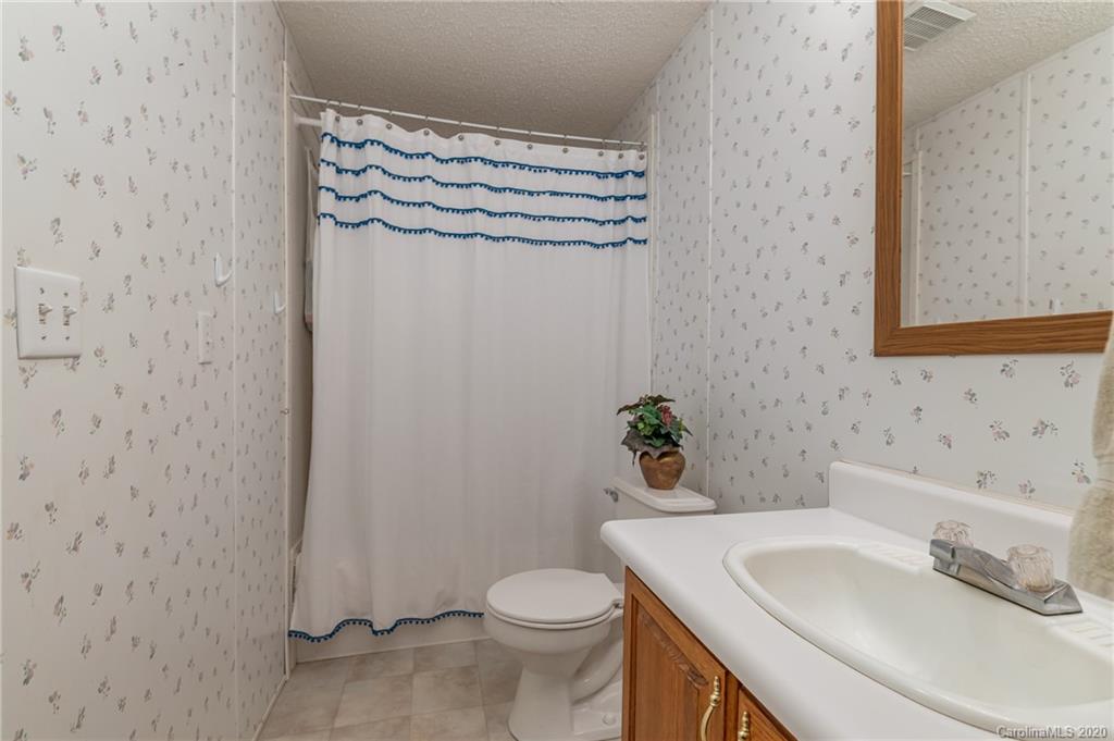 526 Parris Road Rutherfordton, NC 28139 - Photo 25 of 27 a bathroom with a sink a toilet and a mirror
