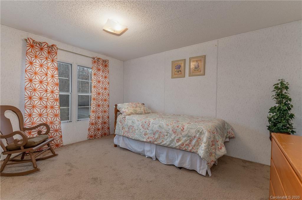 526 Parris Road Rutherfordton, NC 28139 - Photo 27 of 27 a bedroom with a bed and a potted plant