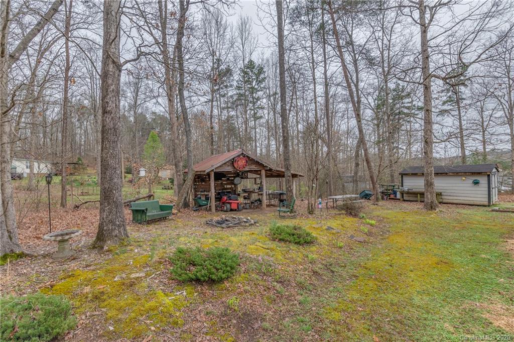 526 Parris Road Rutherfordton, NC 28139 - Photo 8 of 27 a yellow house in middle of the forest