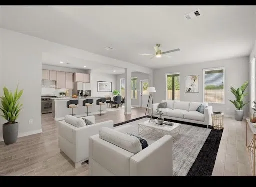 a living room with furniture and a view of kitchen