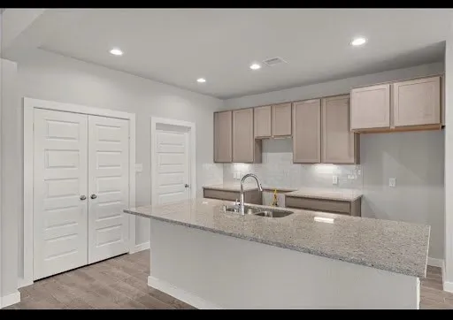 a kitchen with kitchen island white cabinets and stainless steel appliances