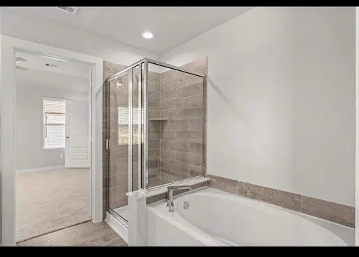 a bathroom with a tub and shower