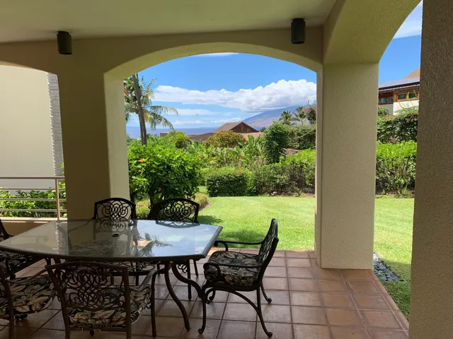 a view of a dining table and chairs in the patio