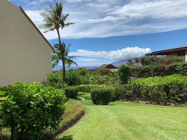 a bedroom with a bed and a lamp on dresser