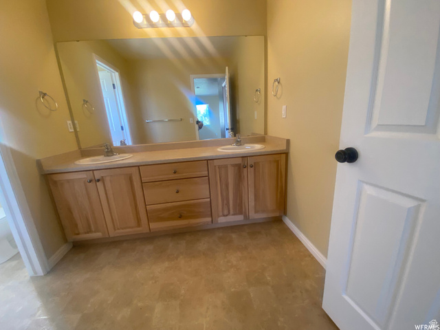 83 Canterbury Circle Logan, UT 84321 - Photo 19 of 23 Full bath with double vanity and light floors