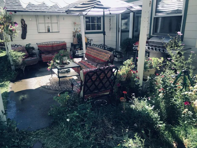 a front view of a house with a yard and a garden