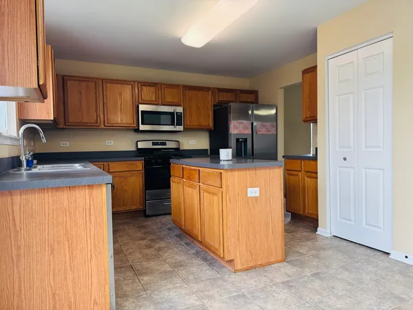 a kitchen with stainless steel appliances granite countertop a stove top oven a sink and dishwasher
