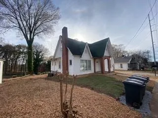 a view of a house with a yard covered in snow