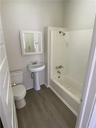 a bathroom with a sink a toilet and a bathtub