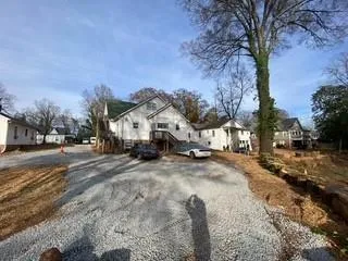 a view of road with card and trees