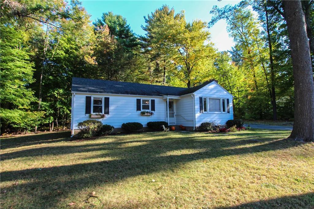 30 Ichabod Road Simsbury, CT 06070 - Photo 1 of 1 a front view of a house with a yard table and chairs