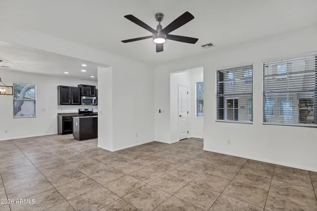 a view of a kitchen with refrigerator and a stove top oven