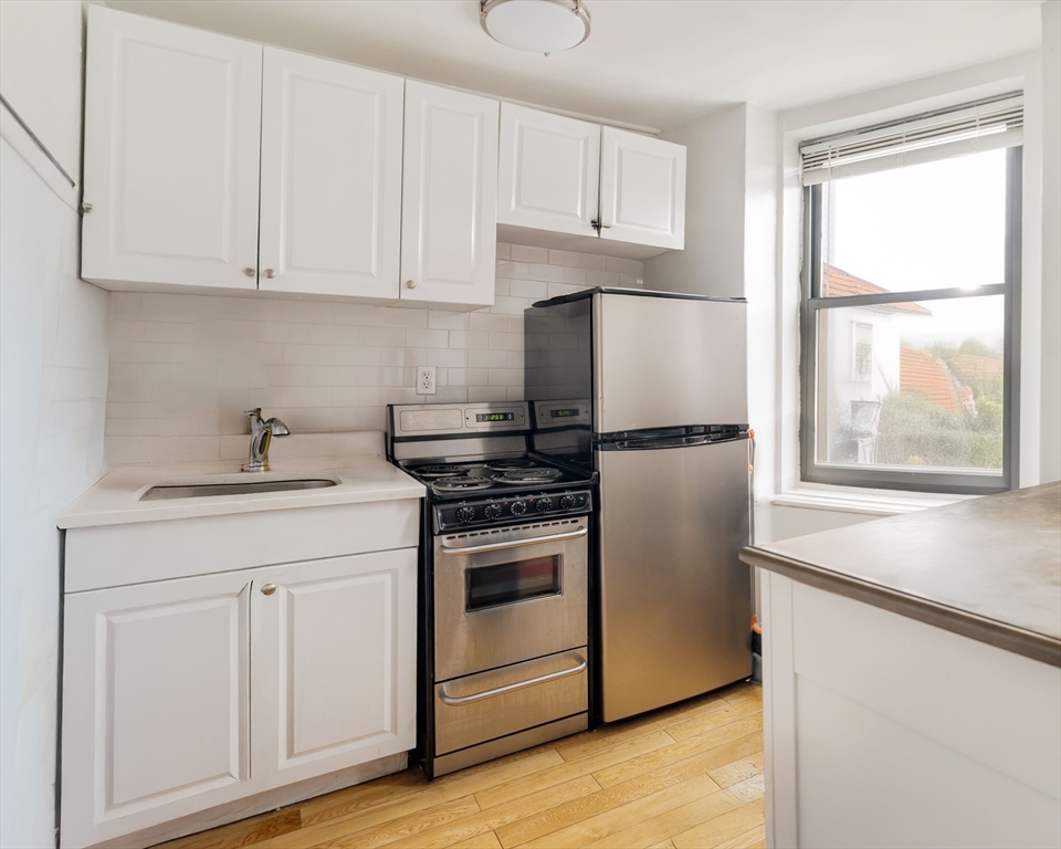 5 North Margin Street, Unit 10 Boston, MA 02113 - Photo 1 of 14 a kitchen with appliances cabinets and a sink