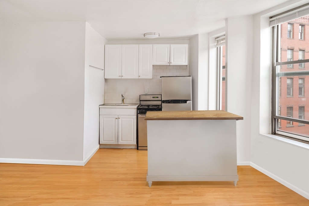 5 North Margin Street, Unit 10 Boston, MA 02113 - Photo 2 of 14 a kitchen with stainless steel appliances a stove refrigerator sink and cabinets