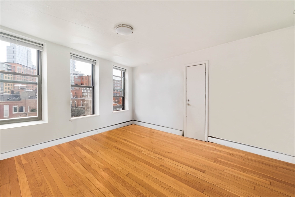 5 North Margin Street, Unit 10 Boston, MA 02113 - Photo 4 of 14 a view of an empty room with wooden floor and a window