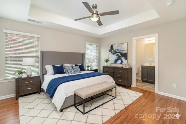 a bedroom with a bed and a chandelier