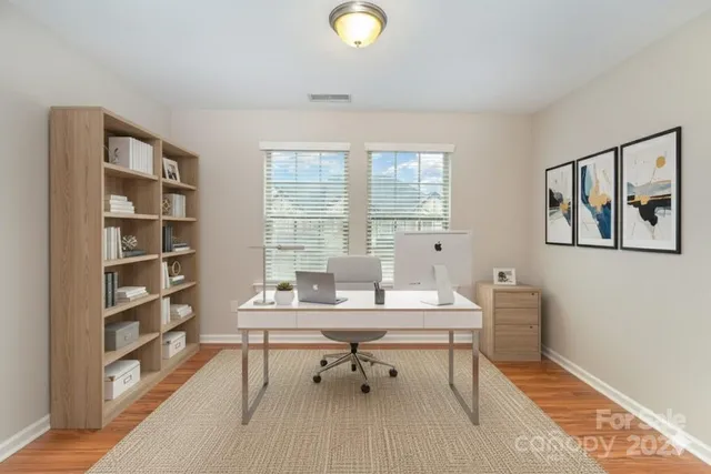 a workspace with furniture window and wooden floor