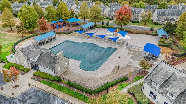 an aerial view of residential houses with outdoor space and parking