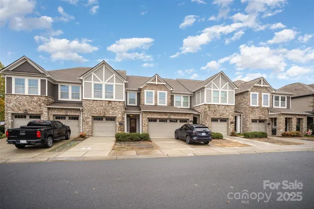 a car parked in front of a white house