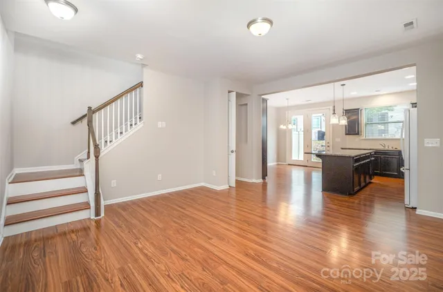 a view of an empty room and wooden floor