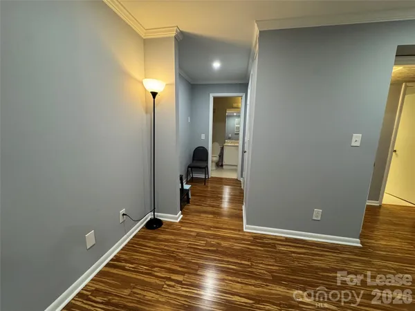 a living room with furniture and a kitchen view