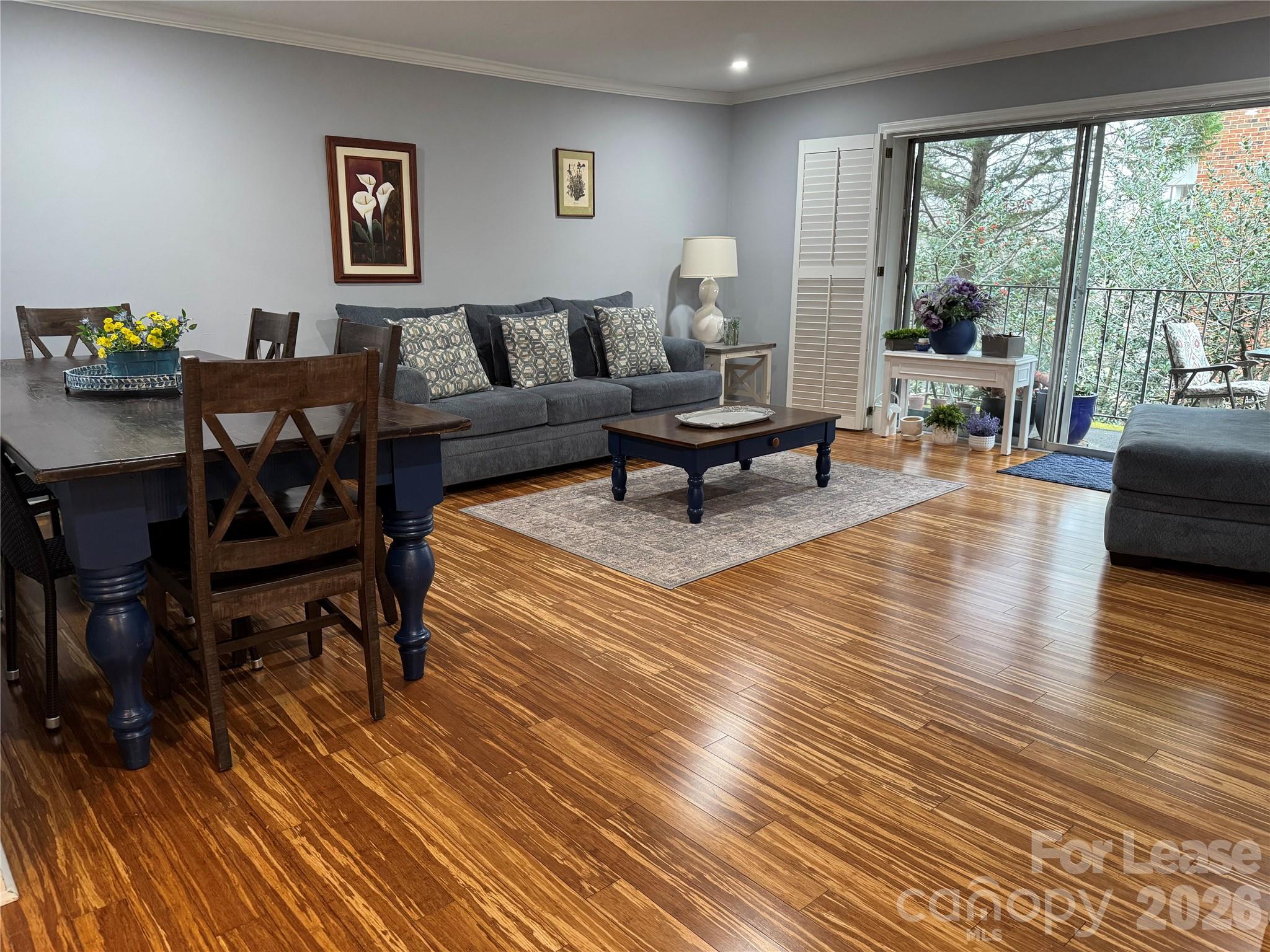 1323 Queens Road, Unit 303 Charlotte, NC 28207 - Photo 2 of 47 a living room with furniture and a wooden floor
