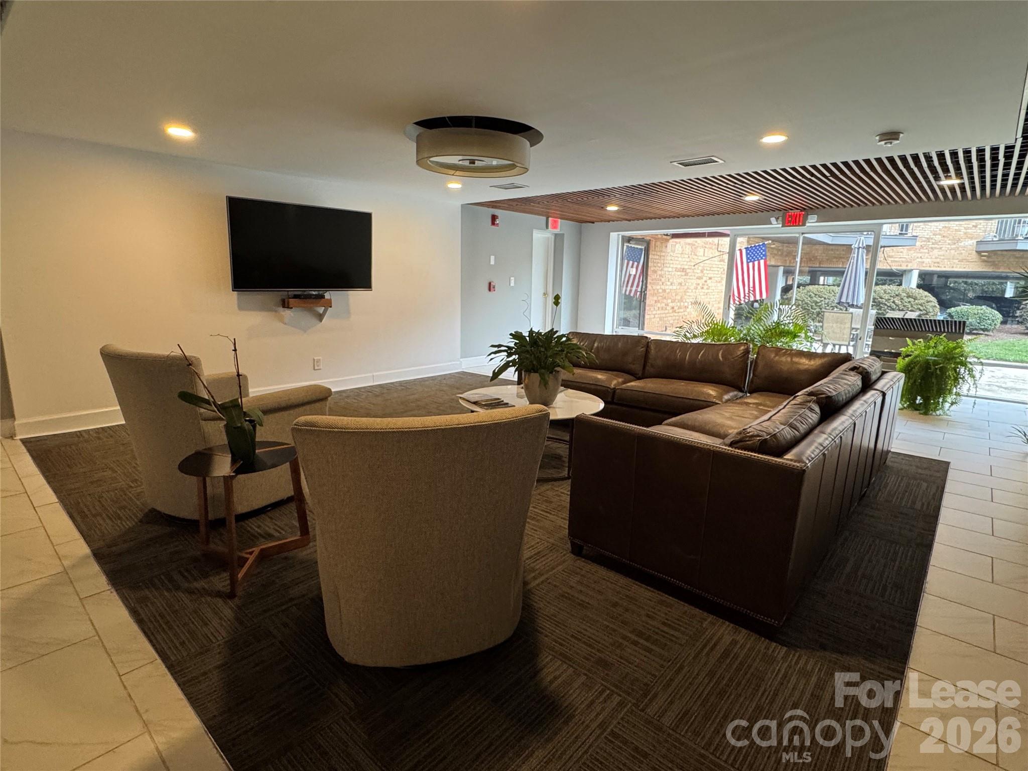 1323 Queens Road, Unit 303 Charlotte, NC 28207 - Photo 30 of 47 a living room with furniture and a flat screen tv
