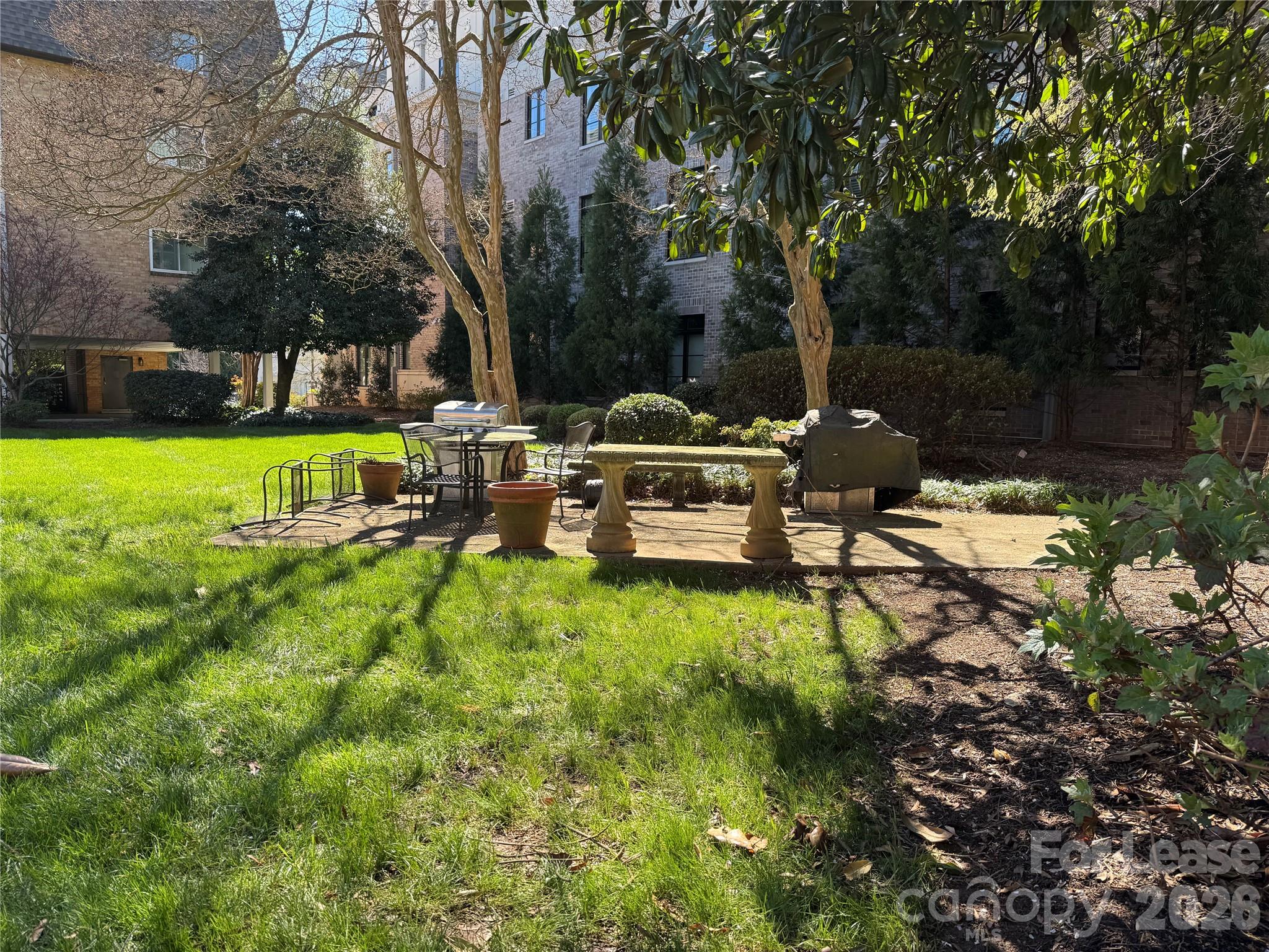 1323 Queens Road, Unit 303 Charlotte, NC 28207 - Photo 39 of 47 a view of backyard with sitting area