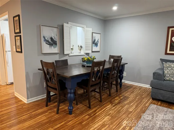 a view of a dining room with furniture and wooden floor