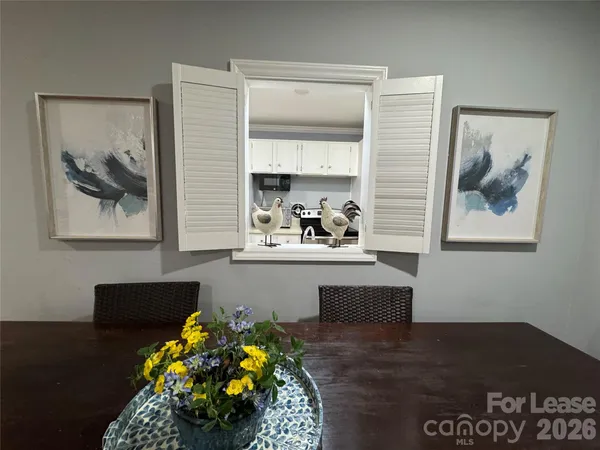 a kitchen with granite countertop white cabinets and stainless steel appliances