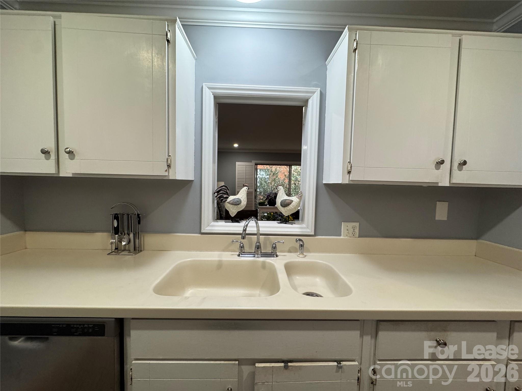 1323 Queens Road, Unit 303 Charlotte, NC 28207 - Photo 10 of 47 a kitchen with a sink and cabinets