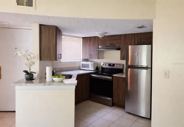 a kitchen with a refrigerator and a sink