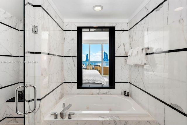 a bathroom with a bathtub and a shower