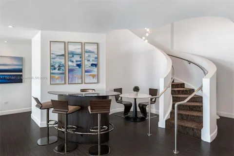 a dining room with furniture and wooden floor