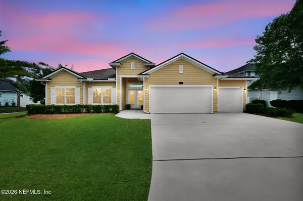 a front view of a house with a yard and garage