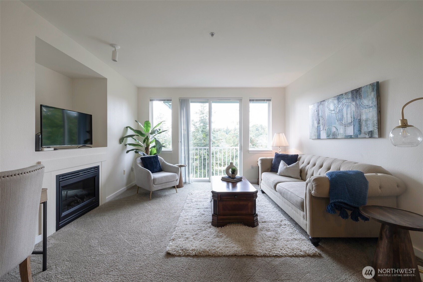 13301 Southeast 79th Place, Unit B402 Newcastle, WA 98059 - Photo 7 of 25 a living room with furniture and a flat screen tv