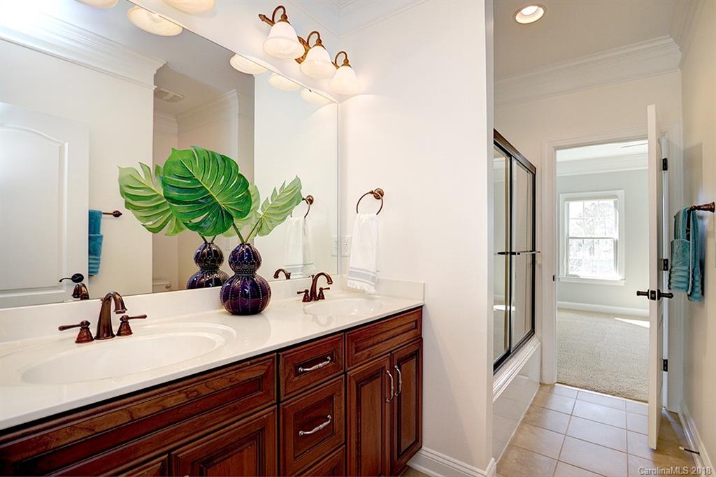 2511 Sharon Road Charlotte, NC 28211 - Photo 22 of 27 a bathroom with a sink a vanity and a mirror