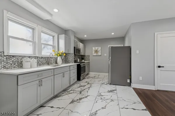 a kitchen with a refrigerator sink and cabinets