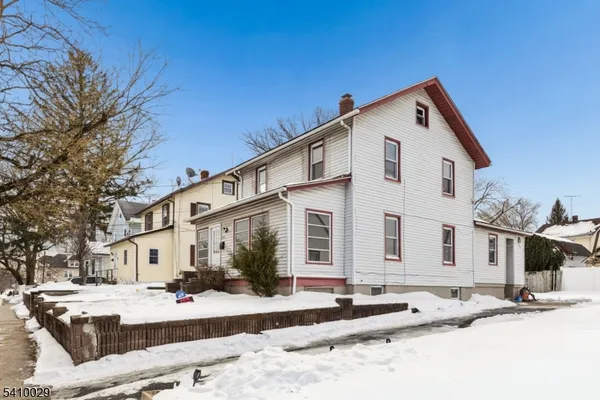a front view of a house with a yard outdoor seating and garage