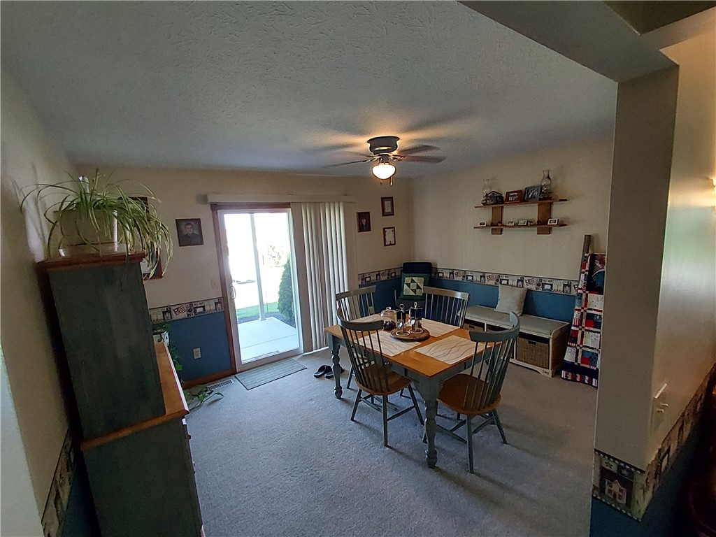 646 North Rangeline Road Pleasant Hill, OH 45359 - Photo 6 of 11 This cozy dining space offers comfortable seating and direct outdoor access through sliding glass doors.