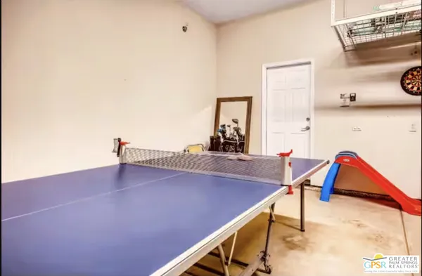 a view of a patio with table and chairs potted plants and a large tree