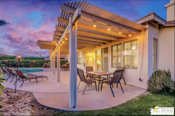 a view of a swimming pool with a table and chairs