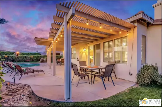 a view of a swimming pool with a table and chairs