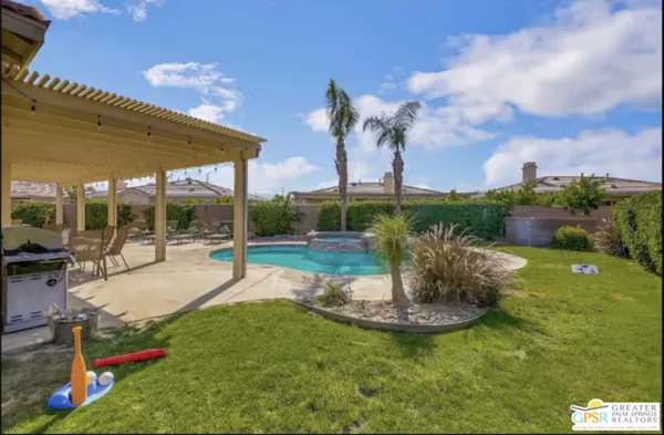 a front view of a house with a yard and fountain