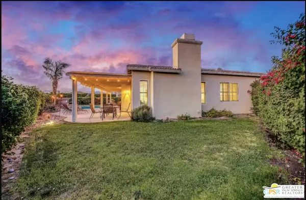 a view of swimming pool with outdoor seating and plants